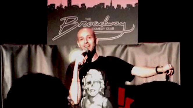 Saitzyk performing stand up comedy at Broadway Comedy Club